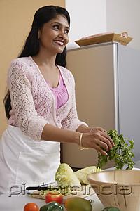 PictureIndia - Indian woman preparing food in the kitchen