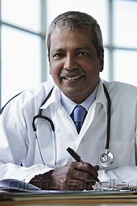 PictureIndia - Indian doctor sitting at desk and smiling