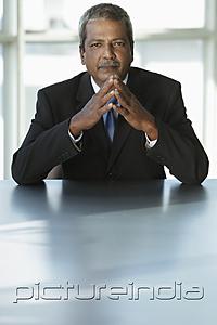 PictureIndia - Indian business man sitting at table