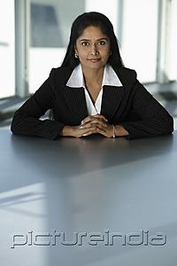 PictureIndia - Indian business woman sitting at table