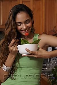 PictureIndia - Young woman eating salad