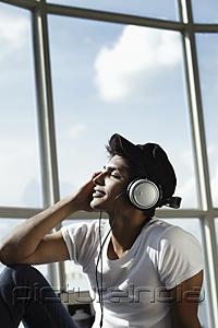 PictureIndia - young man with eyes closed looking up wearing headphones