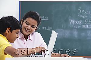 Asia Images Group - teacher working with student at laptop