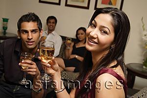 Asia Images Group - couple at party, woman looking at camera, guy looking at woman