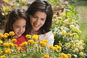 Asia Images Group - mother and daughter look at flowers