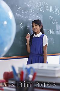 Asia Images Group - girl at chalkboard smiling