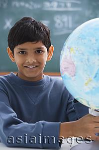 Asia Images Group - boy holding globe, gray sweatshirt