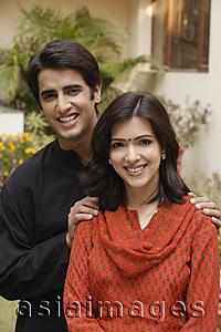 Asia Images Group - husband with hands on wife's shoulders, smiling at camera
