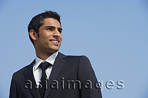 Asia Images Group - businessman smiles, looks back