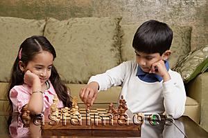 Asia Images Group - boy and girl play chess