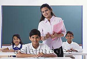 Asia Images Group - three students and teacher smile at camera