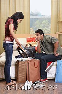 Asia Images Group - woman showing boyfriend shopping