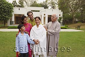Asia Images Group - family in front of home