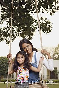 Asia Images Group - mother with daughter on swing