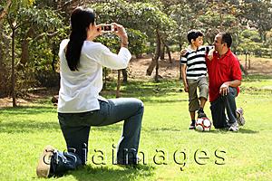 Asia Images Group - Mother taking photo of father and son