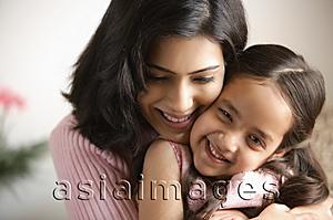 Asia Images Group - close up of mother hugging daughter, girl is smiling at camera