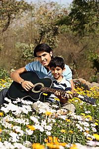 Asia Images Group - Father and son with guitar in park