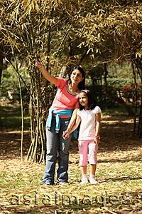Asia Images Group - Mom showing daughter something in park