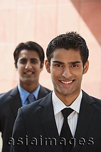 Asia Images Group - two businessmen smiling (vertical)