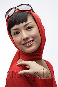 AsiaPix - Portrait of woman wearing red sweater, scarf and sunglasses