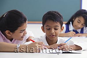 Asia Images Group - teacher helps student with schoolwork