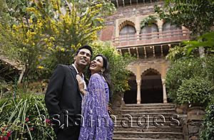 Asia Images Group - young couple in front of old building, embracing