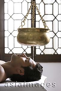 Asia Images Group - young man having Ayurvedic spa treatment