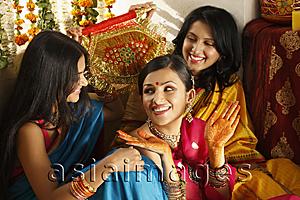 Asia Images Group - three women in saris, one showing her henna hands