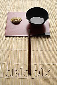 AsiaPix - steam gyoza dumpling with sauce in bowl and chopstick on bamboo mat