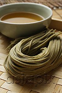 AsiaPix - cooked soba noodles with sauce on the side placed on bamboo tray closeup