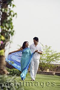 Asia Images Group - young couple strolling in garden