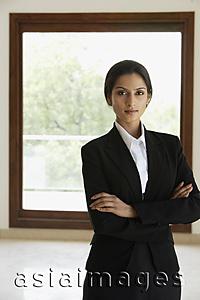 Asia Images Group - Businesswoman standing in front of window