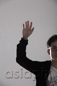 AsiaPix - young man raising his hand