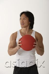 AsiaPix - Chinese man holding medicine ball