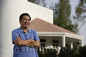 Asia Images Group - smiling man standing in front of house