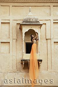 Asia Images Group - young woman in sari, on balcony