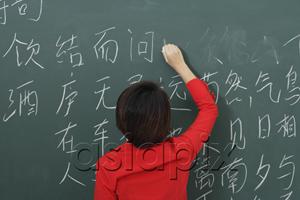 AsiaPix - woman writing Chinese characters on chalkboard