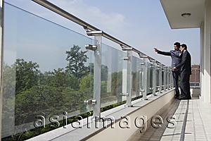 Asia Images Group - businessmen standing at balcony