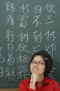 AsiaPix - woman standing in front of chinese characters written in chalk