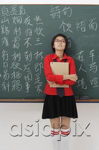 AsiaPix - student standing in front of chinese characters written on chalk board