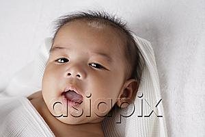 AsiaPix - Head shot of Chinese baby smiling at camera.