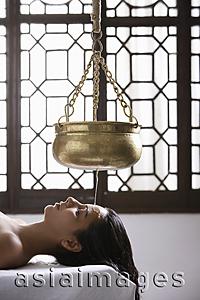 Asia Images Group - young woman having Ayurvedic spa treatment