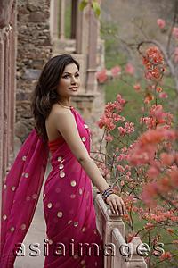 Asia Images Group - young woman in sari standing at terrace balcony