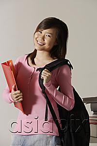 AsiaPix - Young woman carrying back pack and folder.