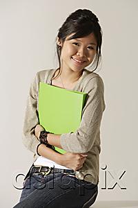 AsiaPix - young woman holding a folder.