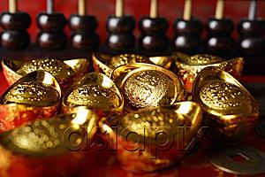 AsiaPix - Close up of Chinese gold ingots and abacus.