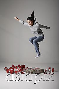 AsiaPix - Young Asian woman jumping on cans