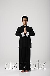 AsiaPix - Man meditating wearing traditional Chinese clothes