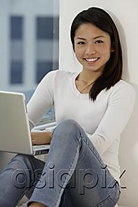 AsiaPix - Young Asian woman working on laptop