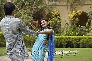 Asia Images Group - young couple dancing in garden